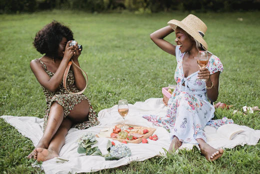 Two women having a picnic with keto friendly snacks