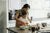A mom and child preparing food in a kitchen